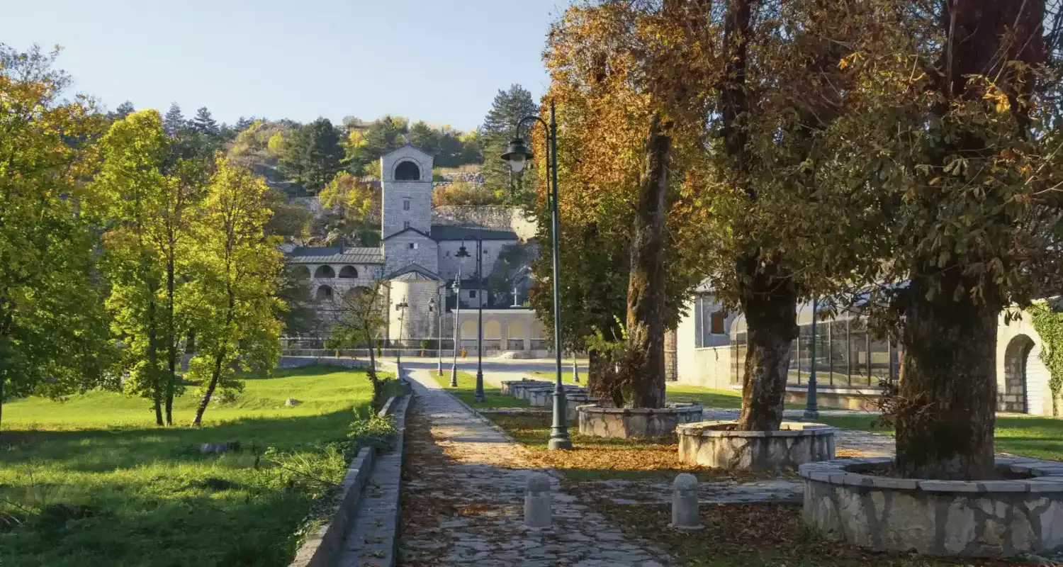 Cetinje Monastery surrounded by autumn foliage.