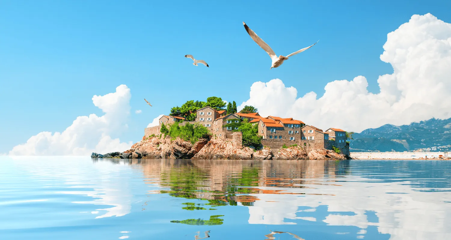 St. Stefan island with seagulls flying over the Adriatic Sea